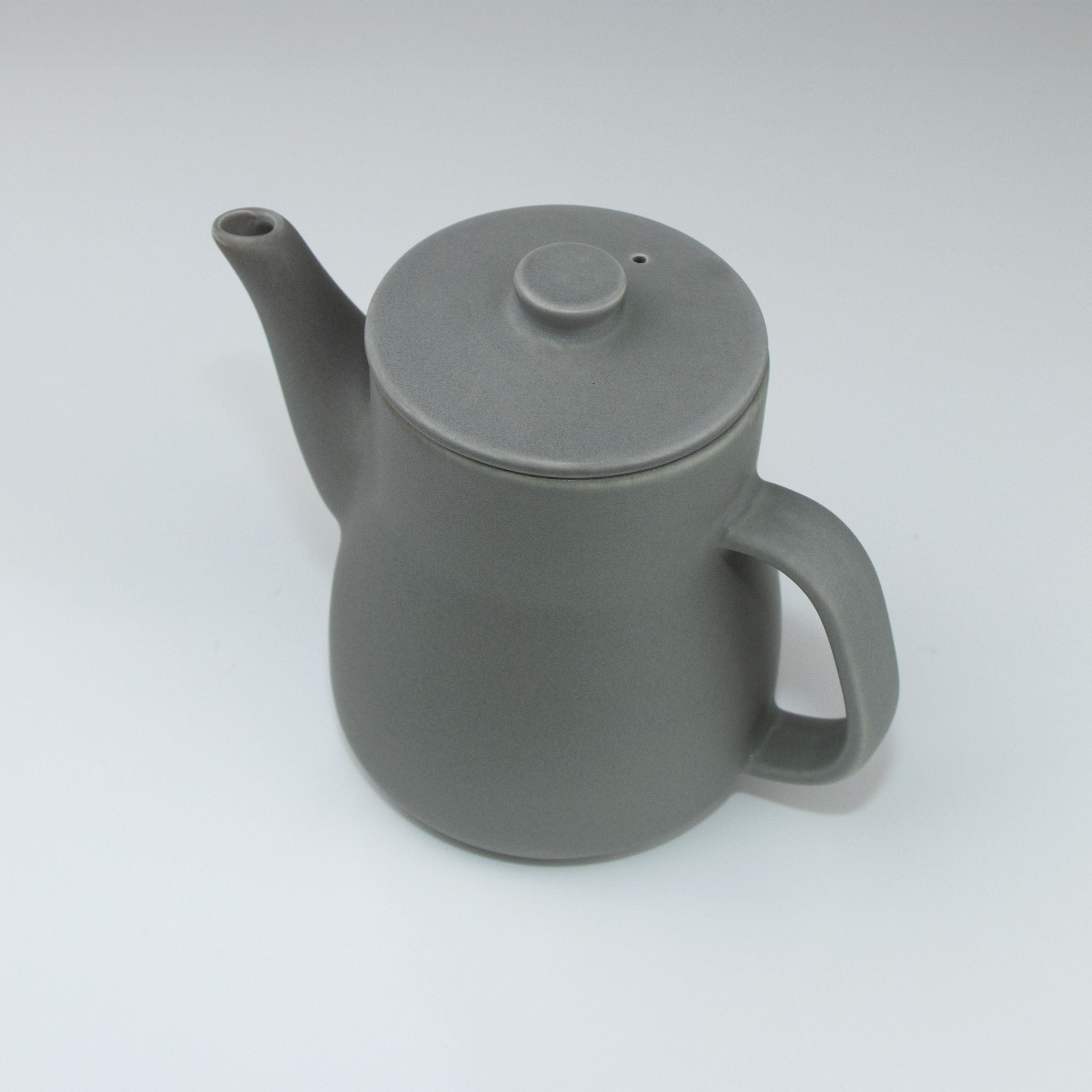 Gray ceramic teapot on a white background