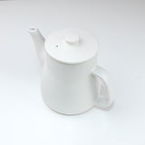 White ceramic teapot on a white background