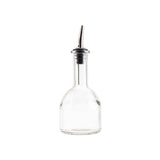 Clear glass bottle with metal nozzle on a white background