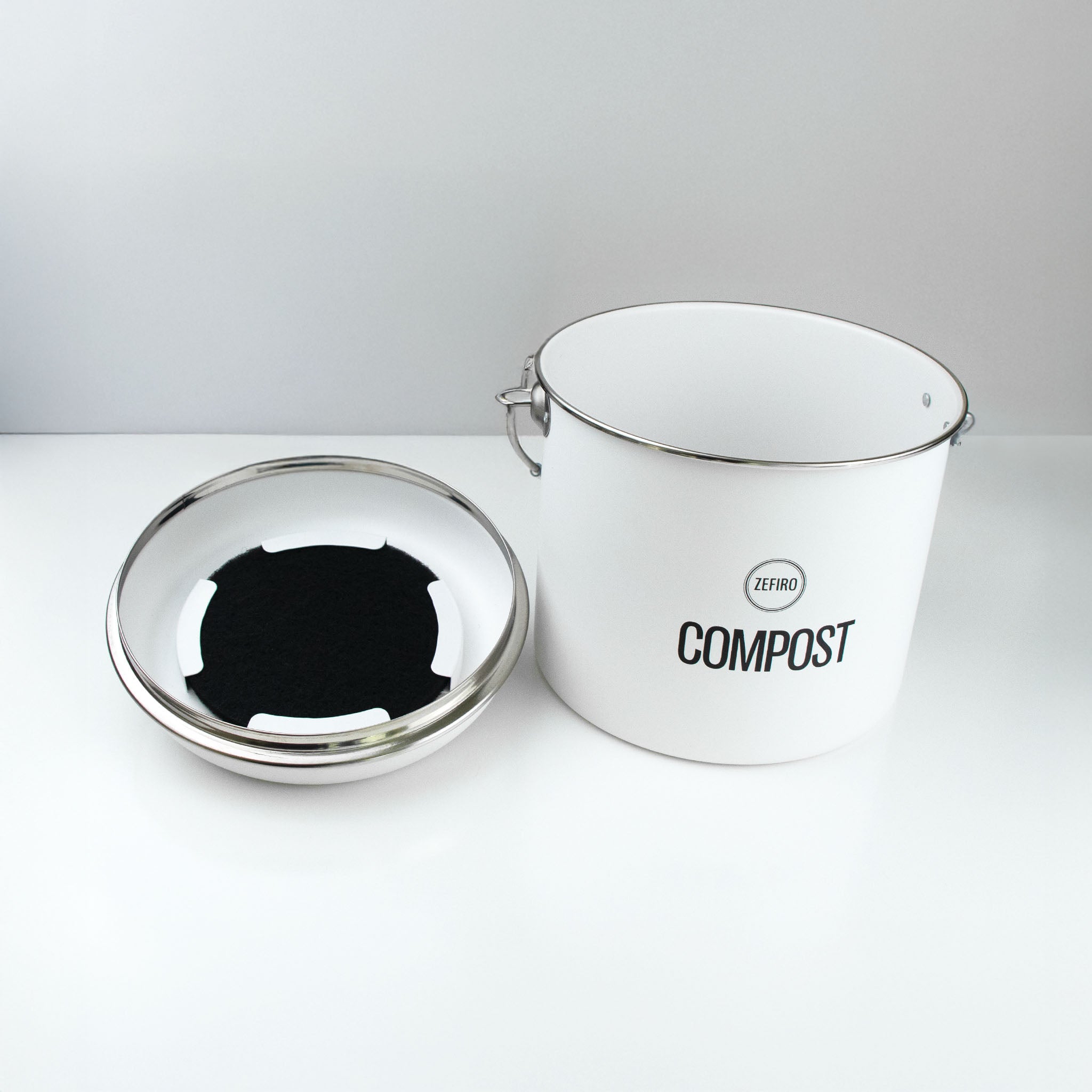 White compost bin with a lid on a white background