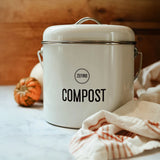 White compost bin with 'Zefiro' branding on a white marble surface with pumpkins.