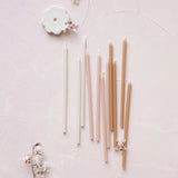 Aesthetic image of The Floral Society's Wishing Candles and Candle Holder on a pale pink background with flowers