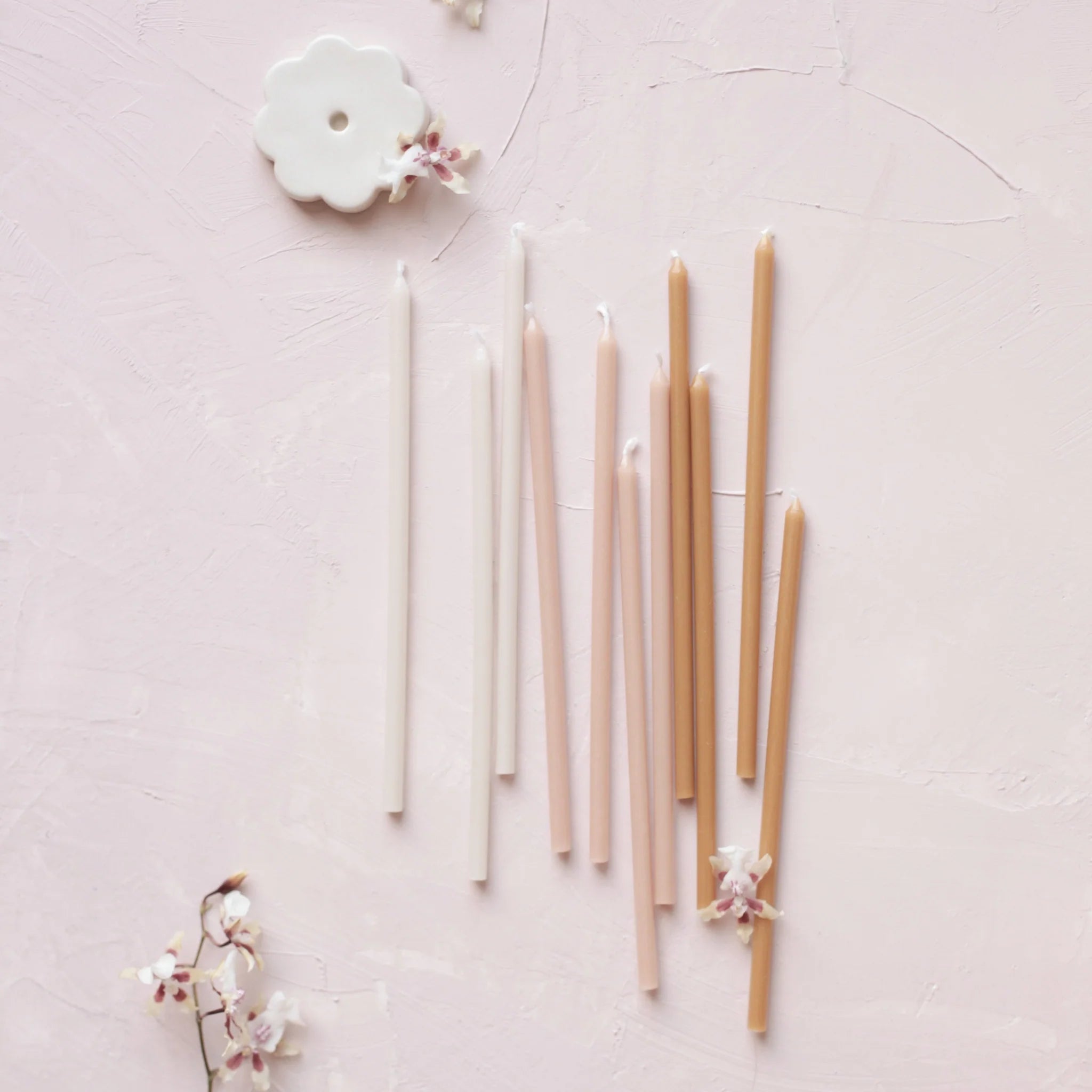Aesthetic image of The Floral Society's Wishing Candles and Candle Holder on a pale pink background with flowers