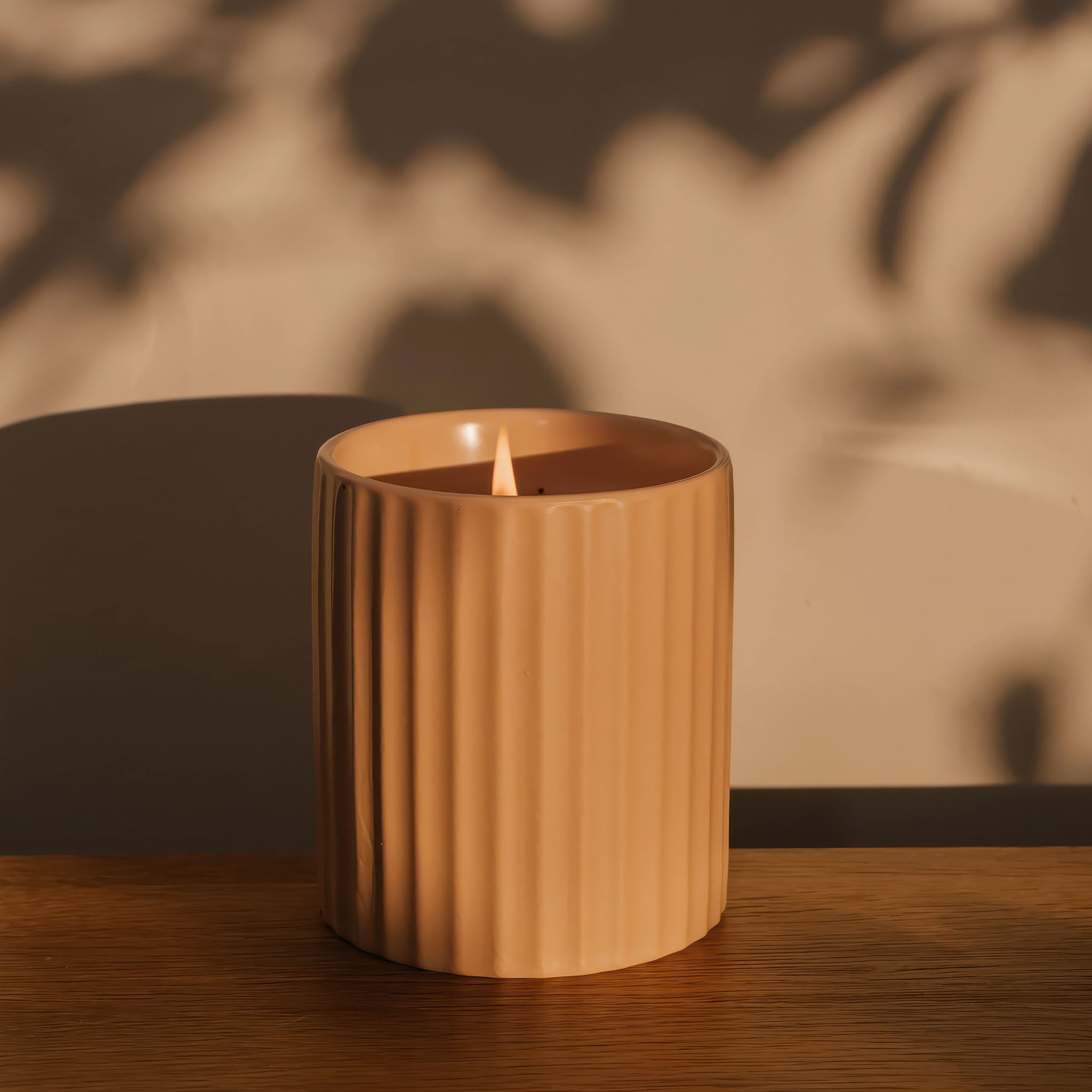 Hudson + Oak's paloma scented candle lit in a warm evening light