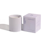 image of hudson oak scented candle wild flower next to box