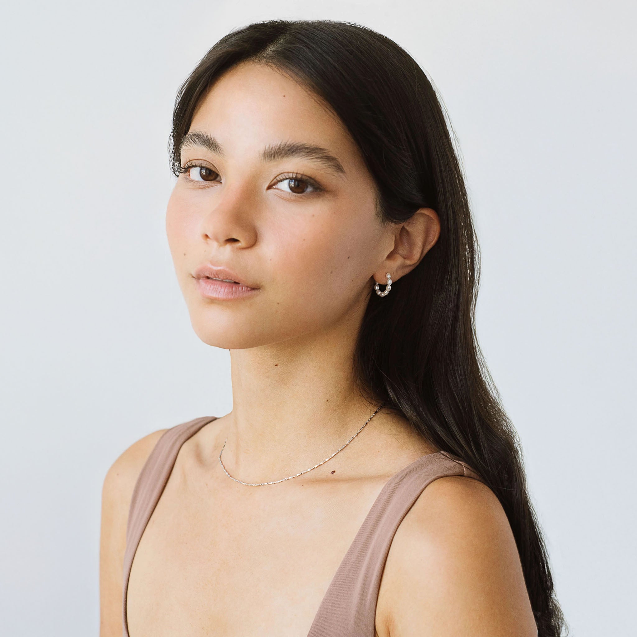 A model wearing Kara Yoo's Baby Rosa hoops