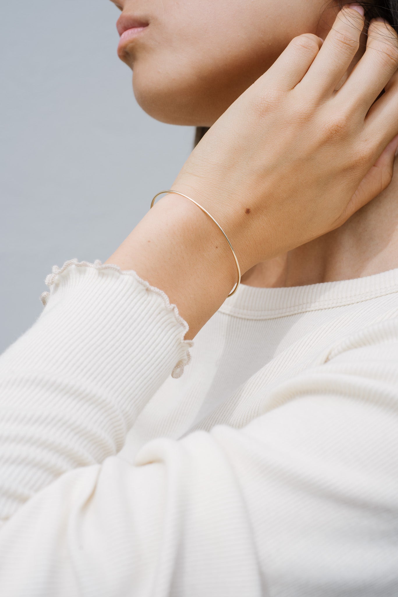 A model wearing the sterling silver thin cuff bracelet