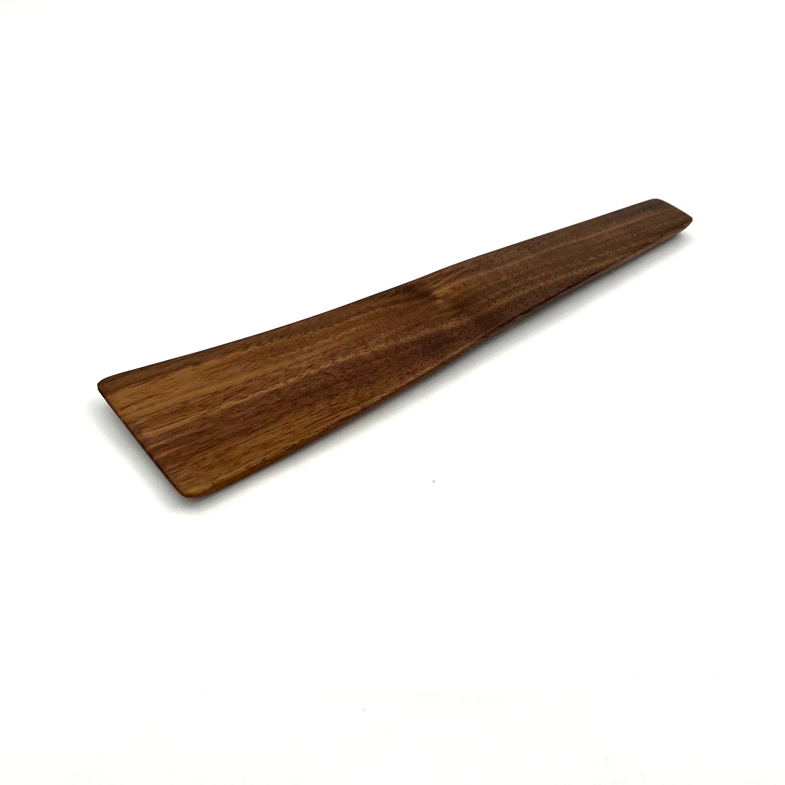 Walnut wooden scraper spatula on a white background