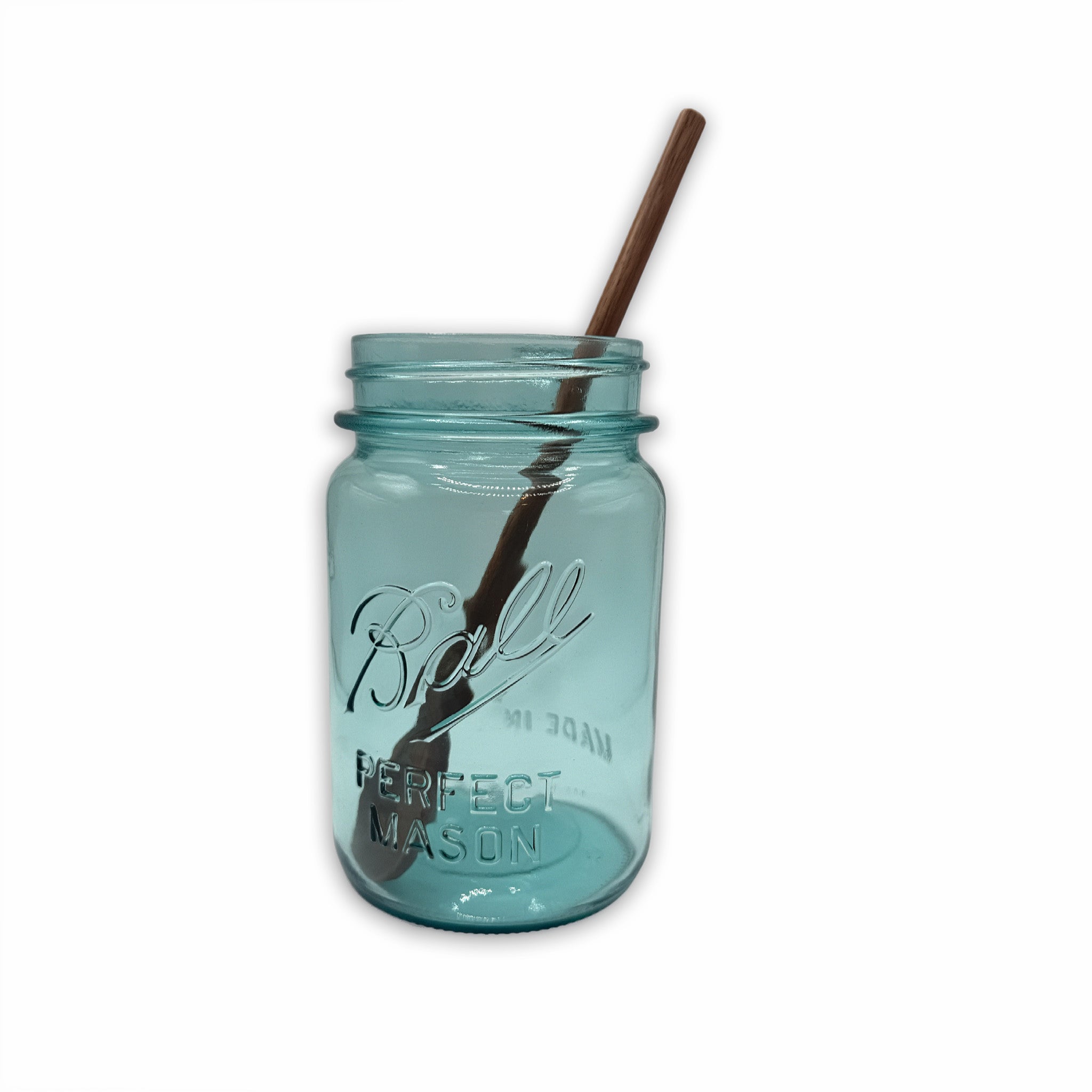 Blue mason jar with an 8in walnut stirring spoon on a white background
