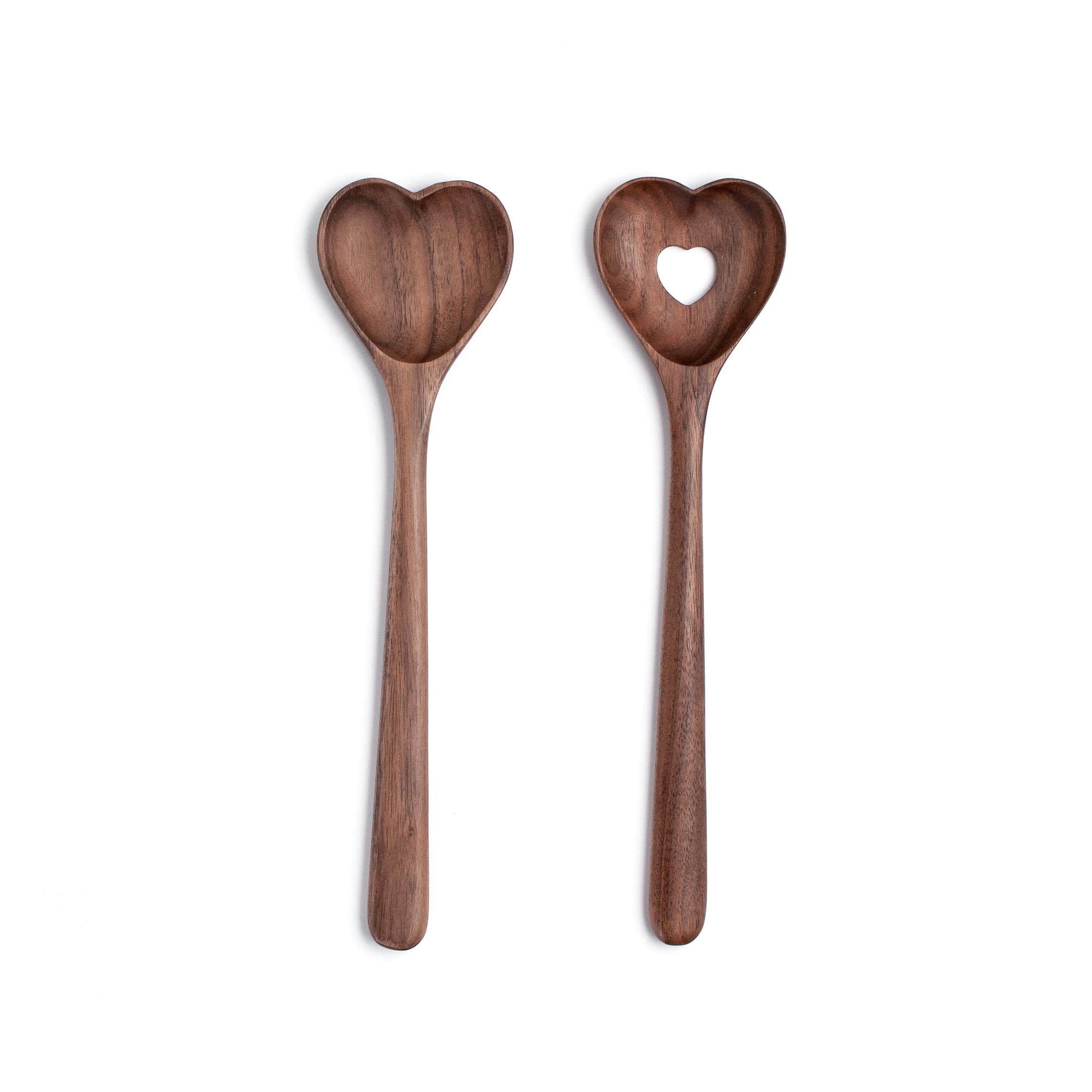 Two wooden spoons with heart-shaped ends on a white background