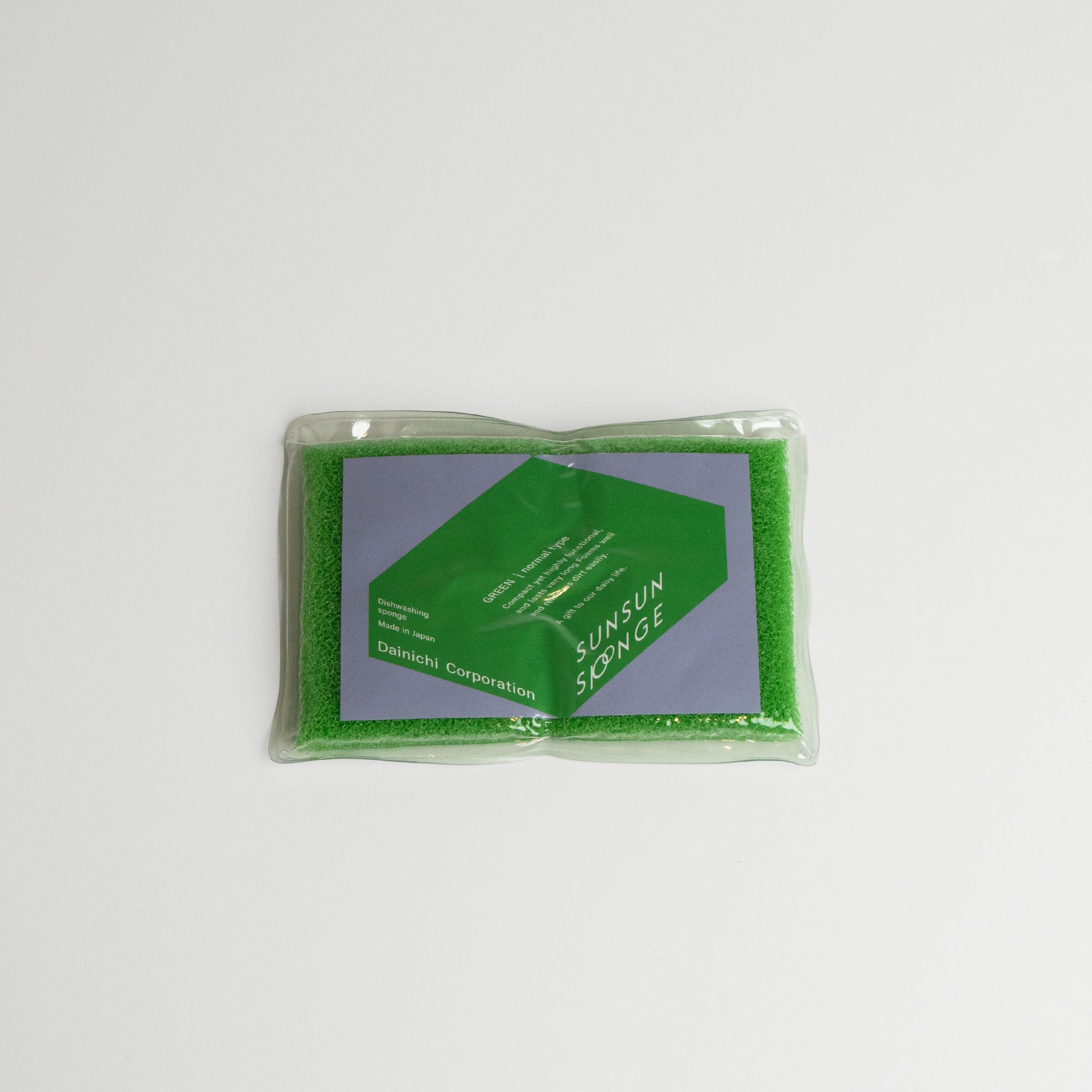 Green Sunsun sponge in clear packaging on a gray background