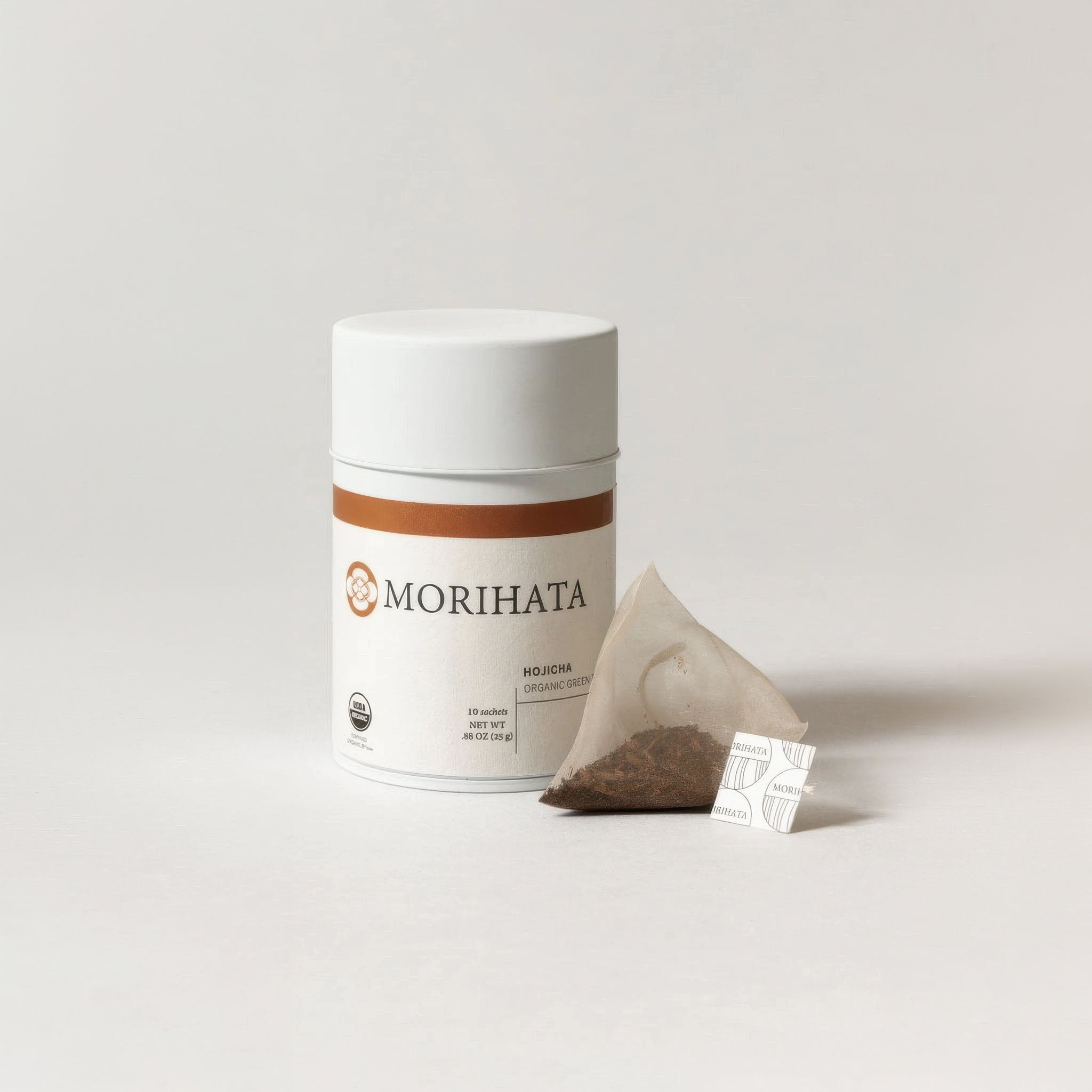 Morihata hojicha tea canister with a tea bag on a light gray background