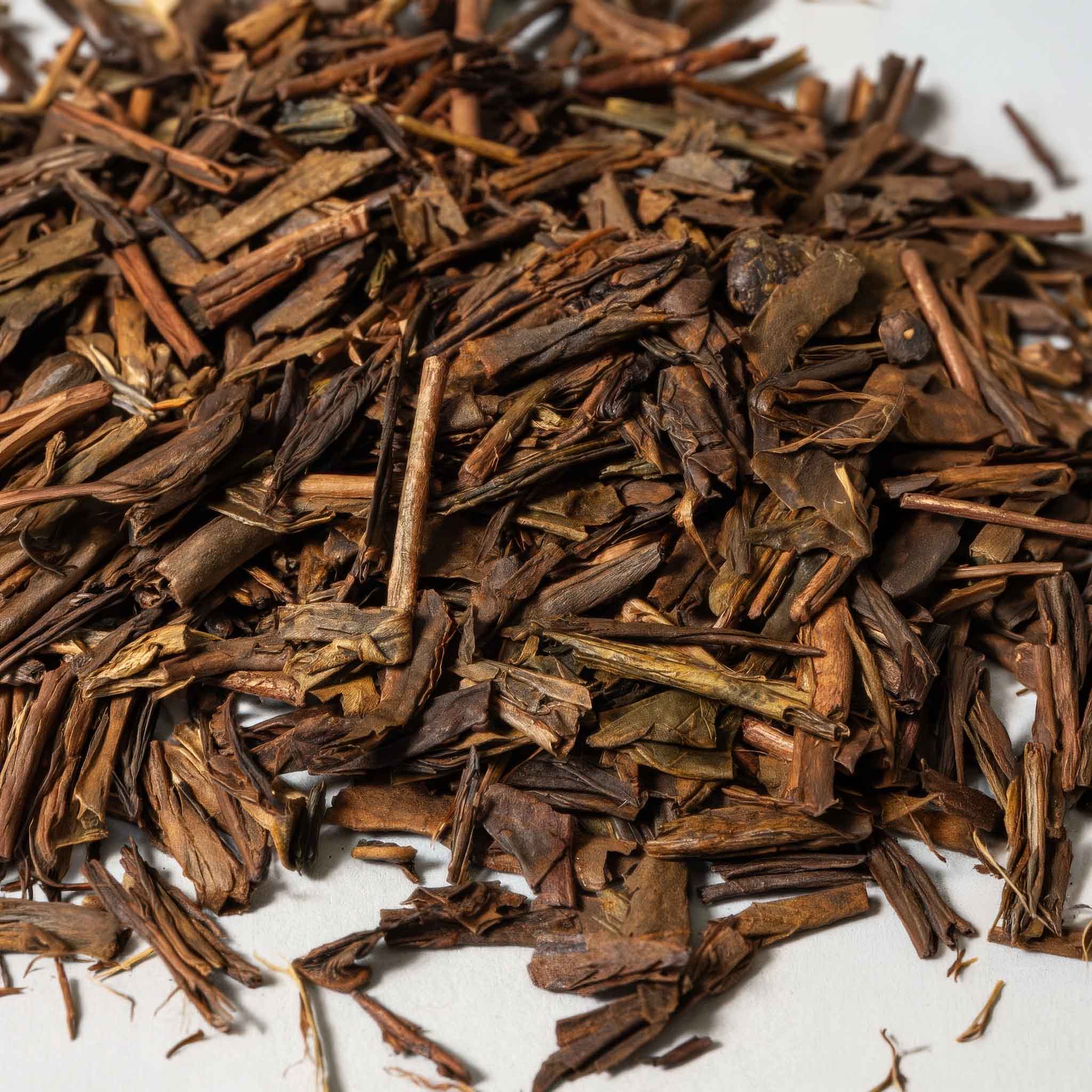 Close-up of hojicha tea leaves on a white background