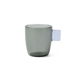 Grey glass mug with a lavender handle on a white background