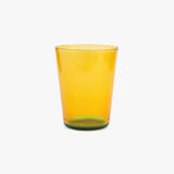 Two tone yellow glass tumbler on a white background