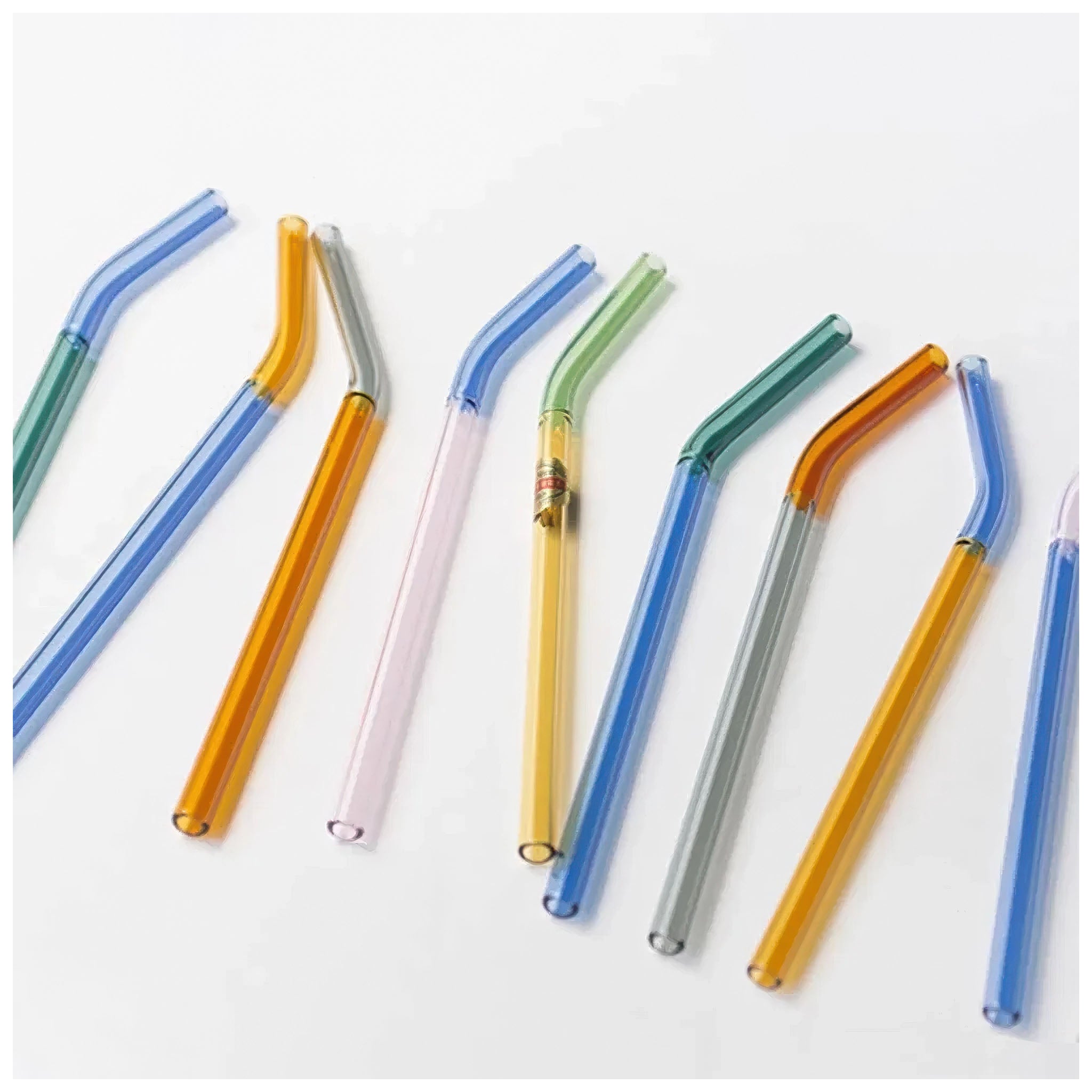 Set of colorful glass straws on a white background