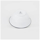 White enamelware bowl with a dark navy trim on a white background