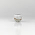 Small handcrafted ceramic sake cup with white glaze and exposed clay band, made by The Lazy Potters.