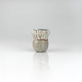 Handcrafted fluted ceramic sake cup with white glaze and ribbed texture, by The Lazy Potters.