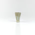 Tapered handmade ceramic sake cup with pale celadon glaze and raised clay foot, by The Lazy Potters.