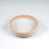 Limited edition off-white ceramic ttukbaegi  pot only with terrapcotta colored rim on a white background