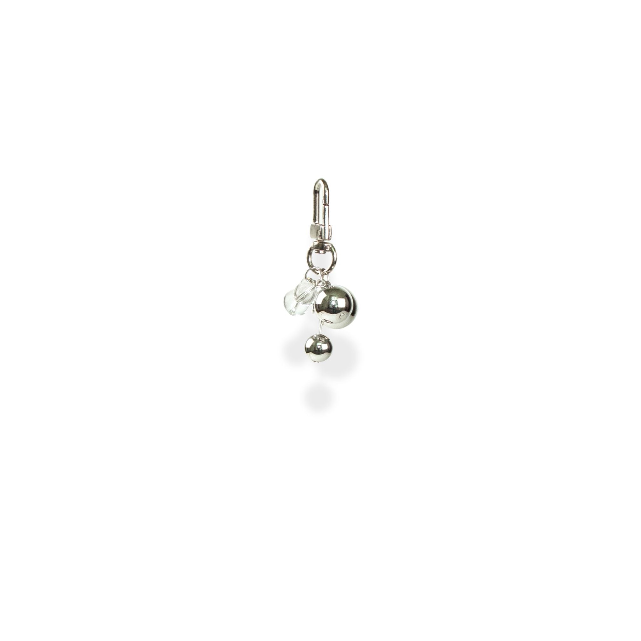Side angle of silver charms with clear beads on a white background