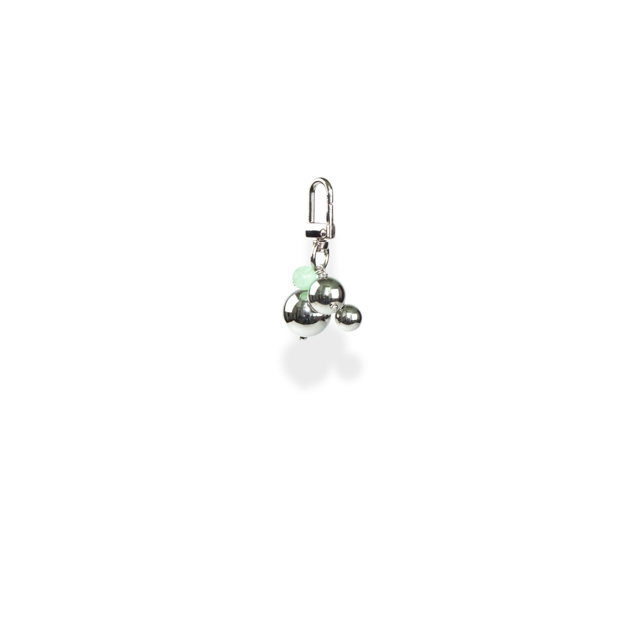 Silver charm with a green bead on a white background