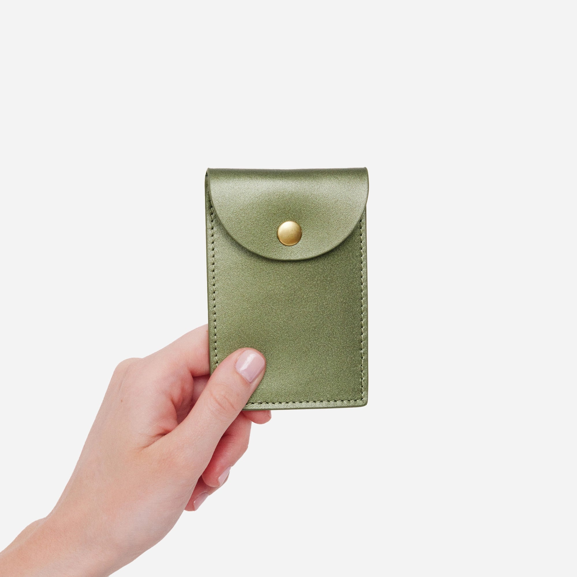 Hand model holding Minor History's The Biggie Credit Card case in color jade