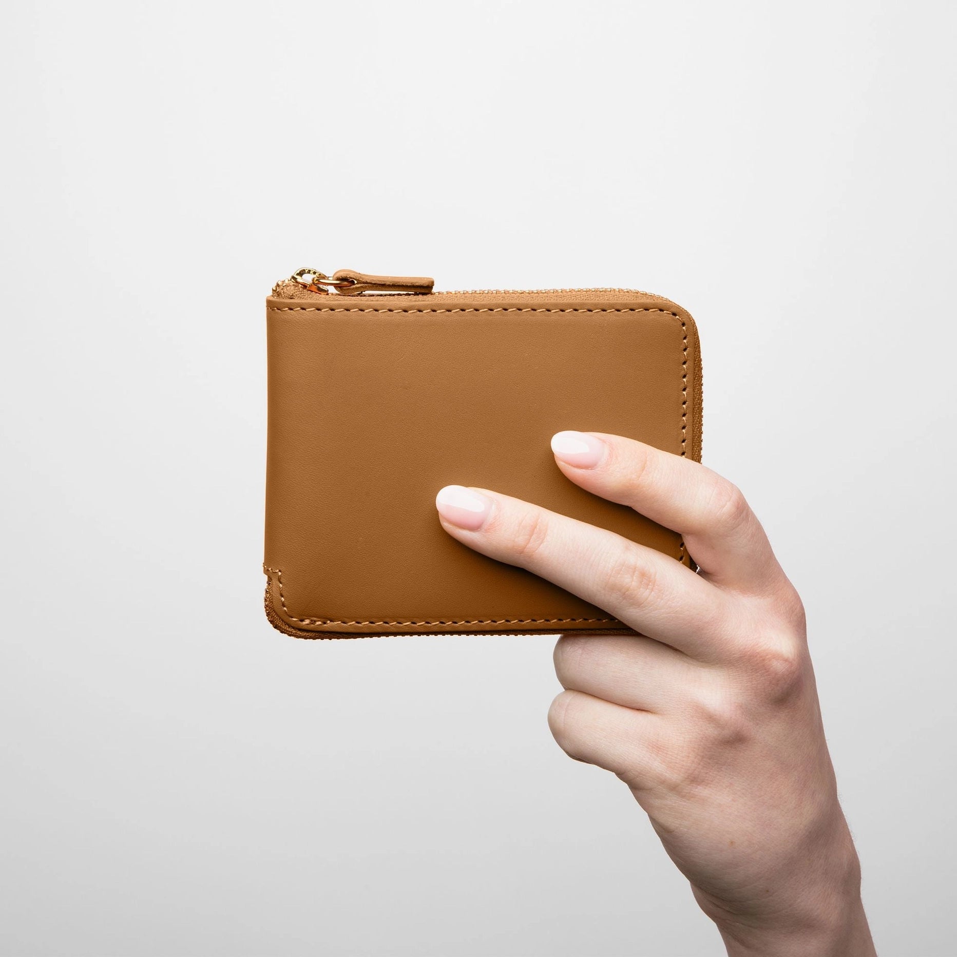 a hand model holding minor history the coupe wallet color saddle