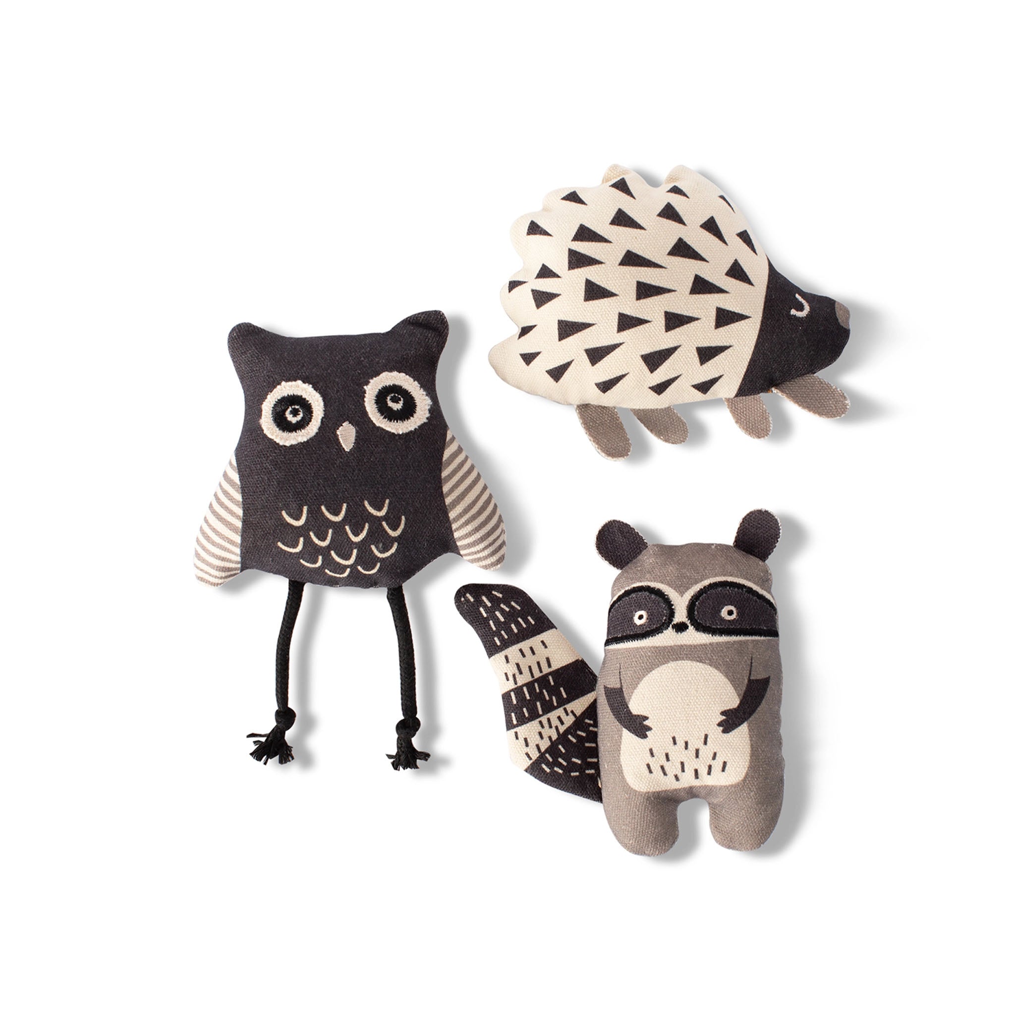 Set of three plush dog toys shaped like an owl, hedgehog, and raccoon on a white background