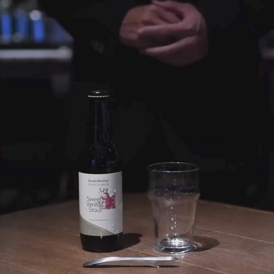 A person demonstrating the magnetic feature of the Suwada bottle opener