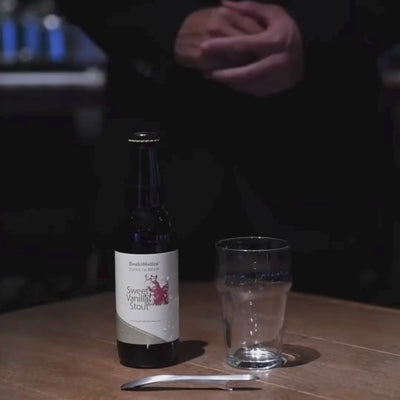 A person demonstrating the magnetic feature of the Suwada bottle opener