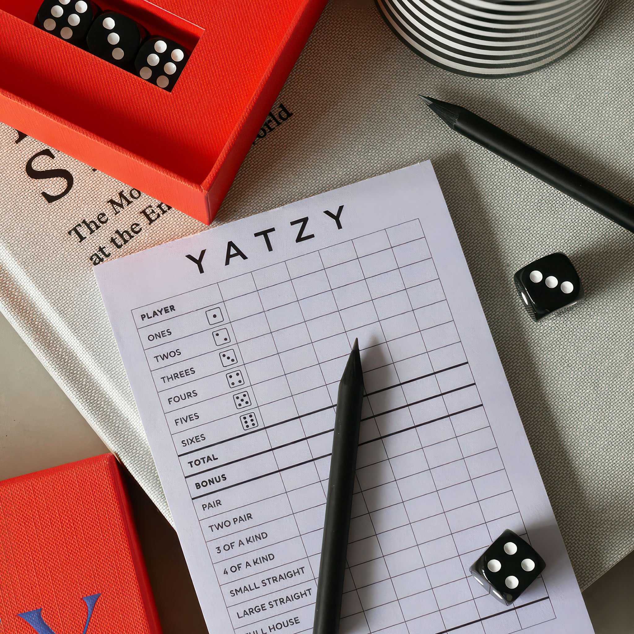 image from above printworks yatzy game showing note pad and two dice