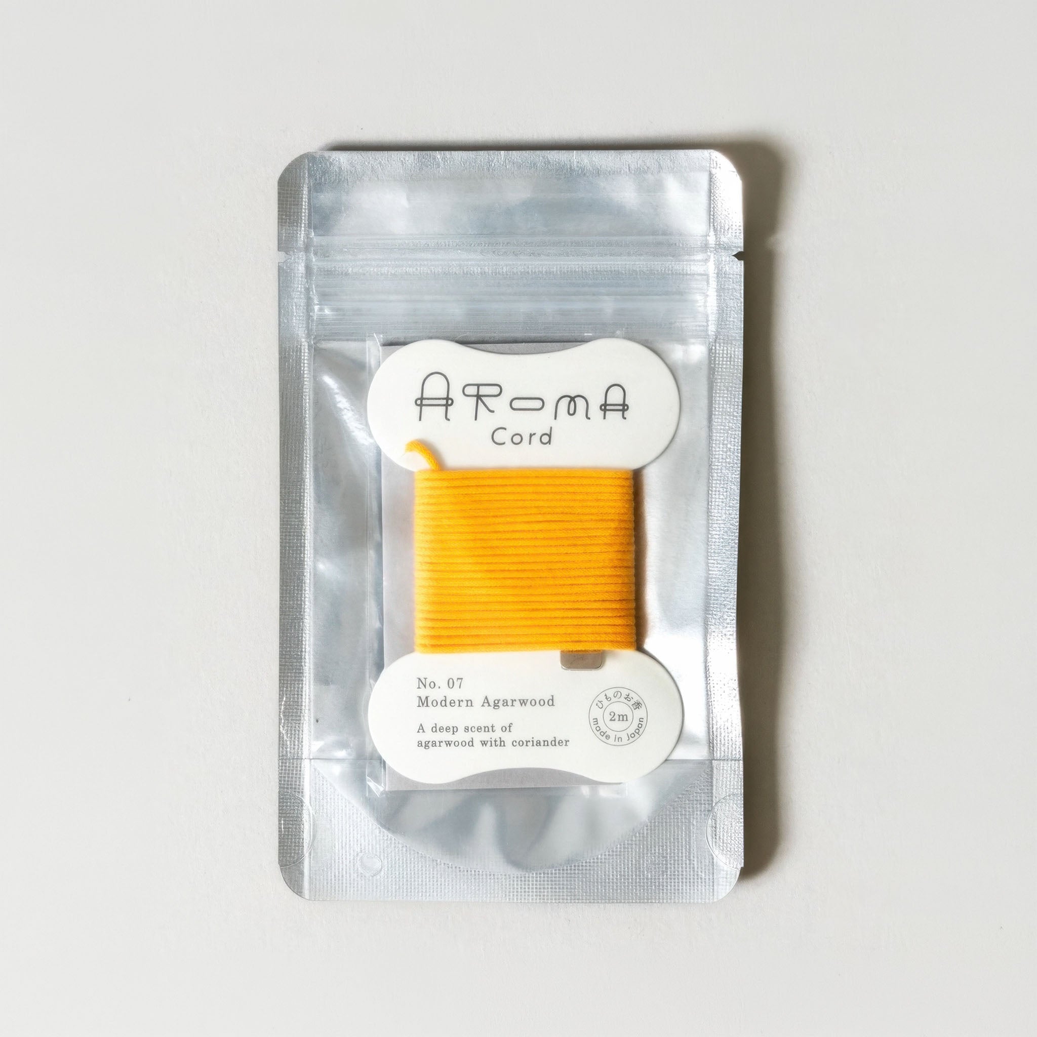 'Aroma Cord' No. 01 Deep Ocean in its original silver packaging on a light gray background