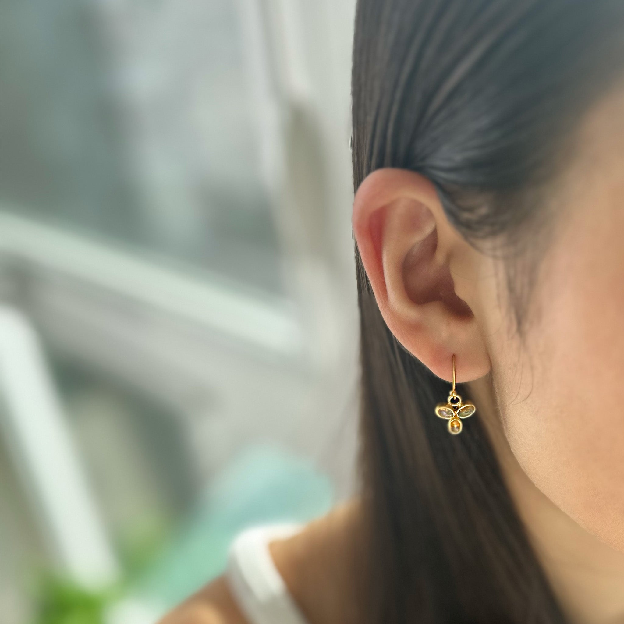 image of model wearing s river song earring