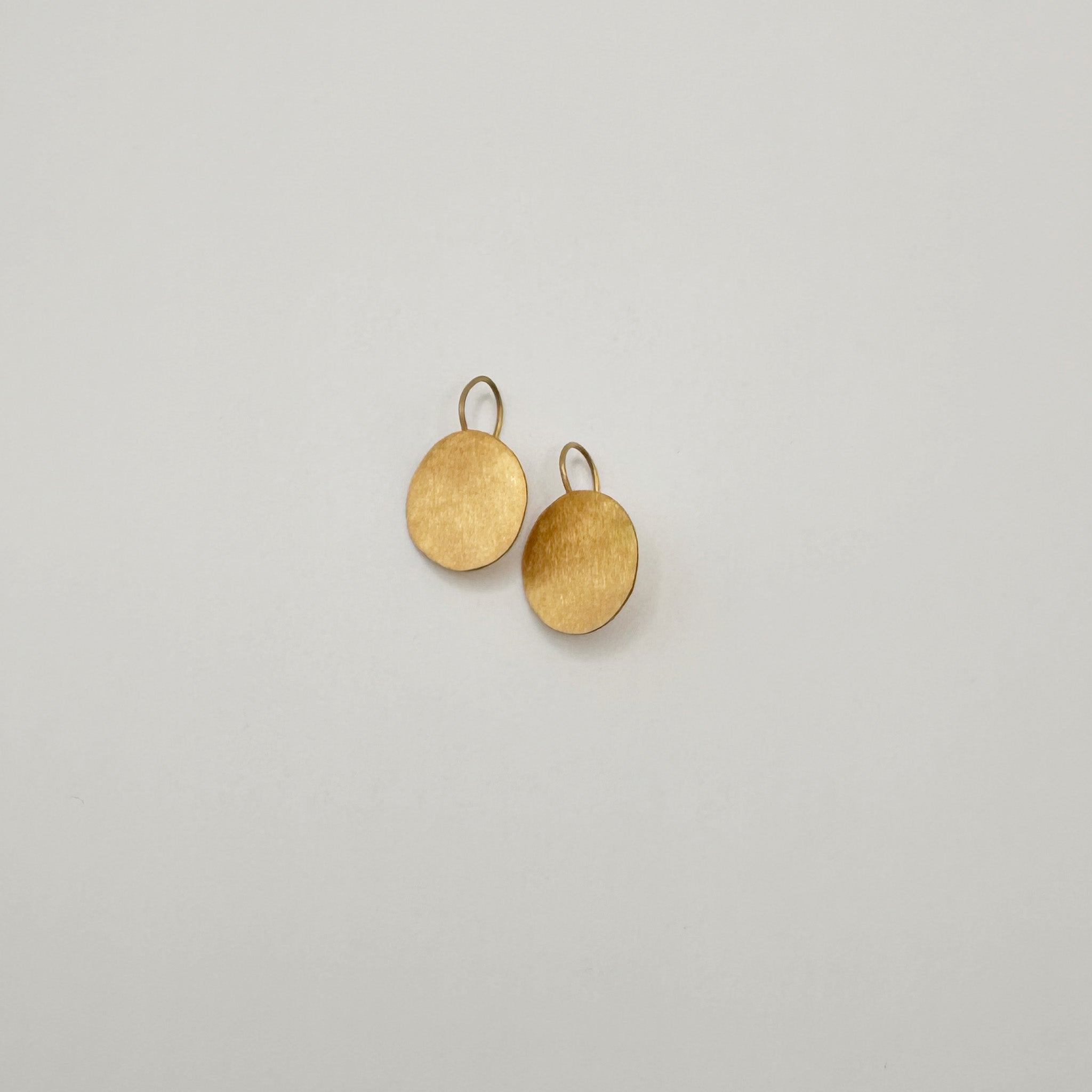 image of two river song earrings handcut gold coin design