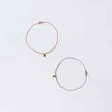 image of two see real flowers bracelets blossom charm lying next to each other latched in circular form