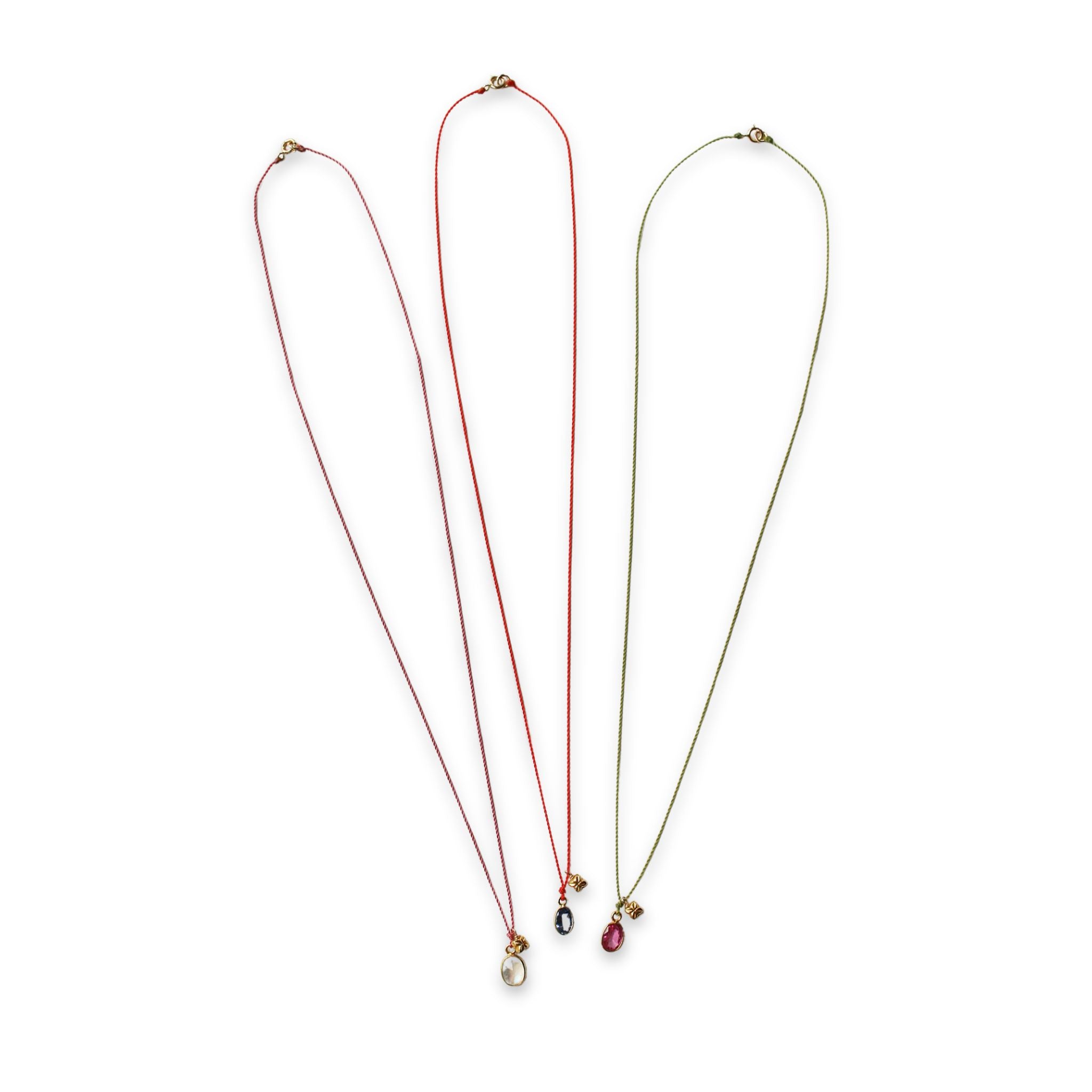 full image of three see real flowers necklaces with blossom charm hanging next to each other