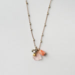 close up image of see real flowers necklace charm design