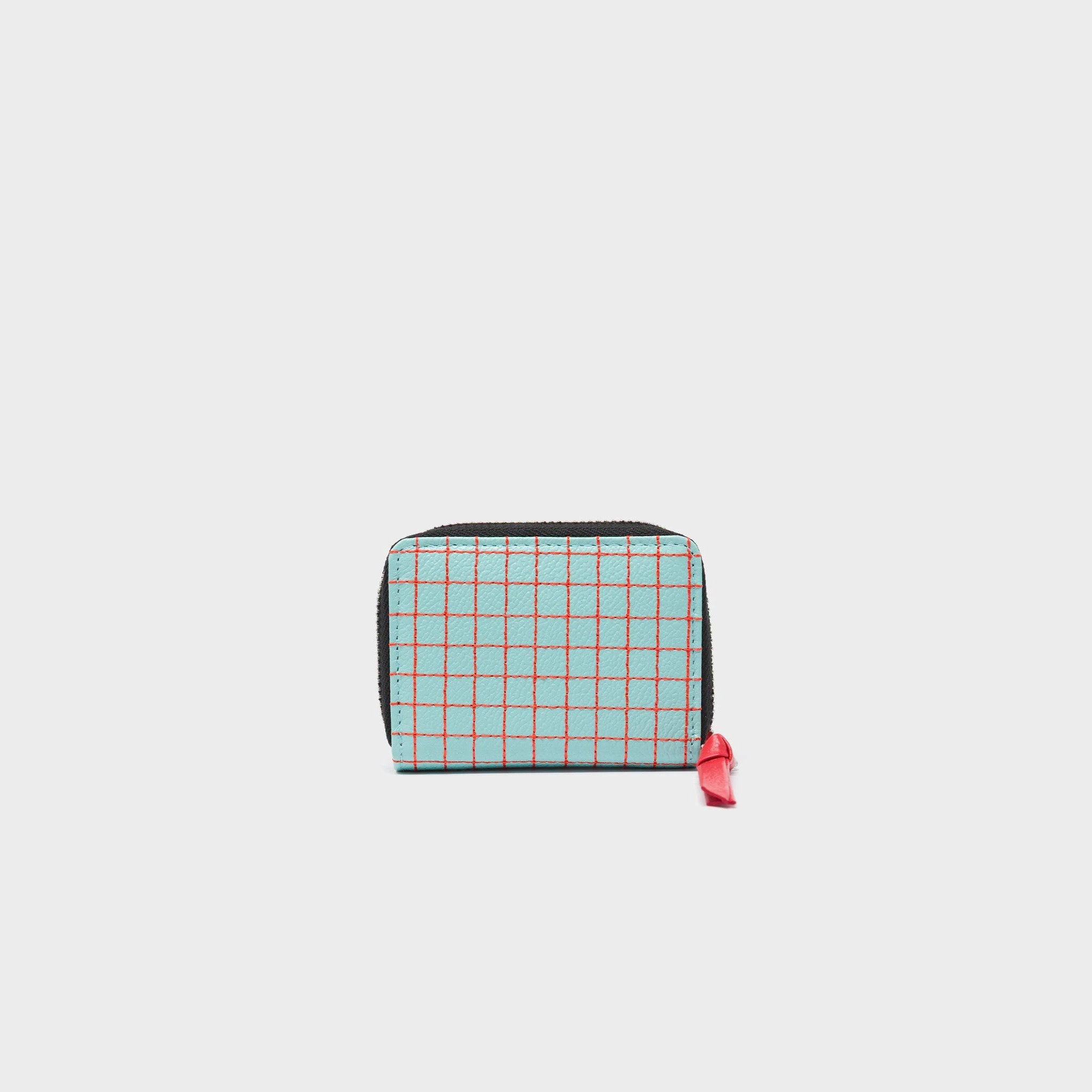 Back of a small wallet with eye, heart, and crown designs on a light gray background