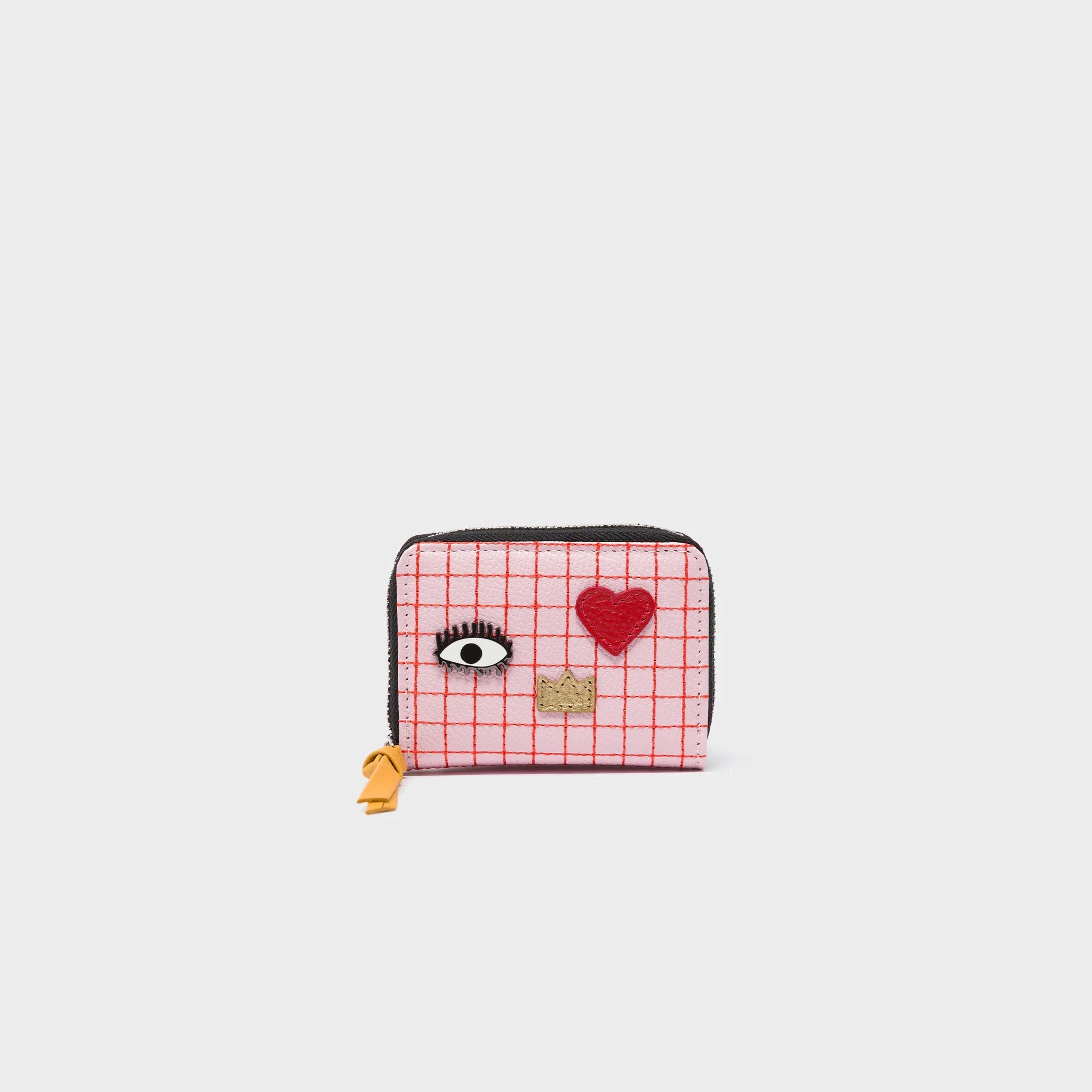 Small wallet with a pink checkered pattern, eye design, and red heart on a light gray background
