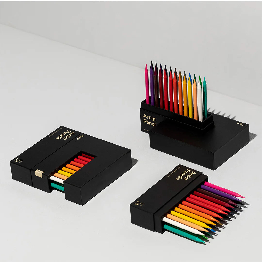 Sets of the Karst colored pencils in black boxes on a light gray background