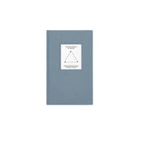 Top view of The Anti-Anxiety Notebook by Therapy Notebooks, featuring a linen hardcover with a minimalist stitched patch.