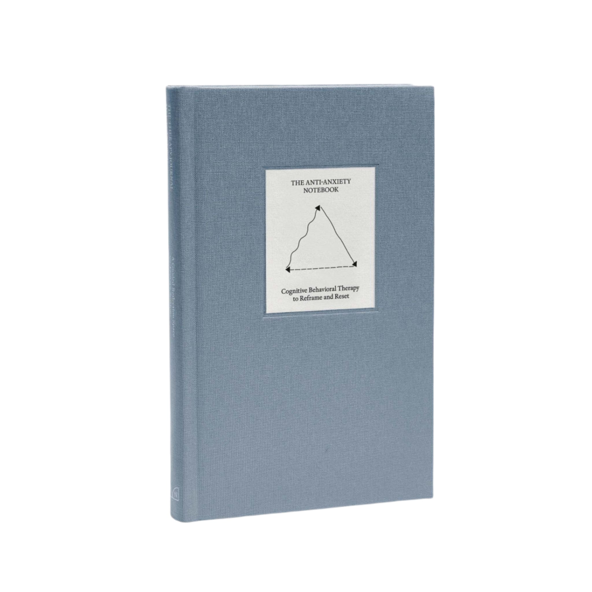 Full angled view of The Anti-Anxiety Notebook by Therapy Notebooks, featuring a linen hardcover with a minimalist stitched patch.