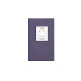 Top view of The Anti-Insomnia Notebook by Therapy Notebooks, featuring a linen hardcover with a minimalist stitched patch.