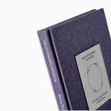 Close-up of The Anti-Insomnia Notebooks by Therapy Notebooks, featuring a linen hardcover with a minimalist stitched patch and embossed spine text.