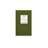 Top view of The After Trauma Notebook by Therapy Notebooks, featuring a linen hardcover with a minimalist stitched patch.