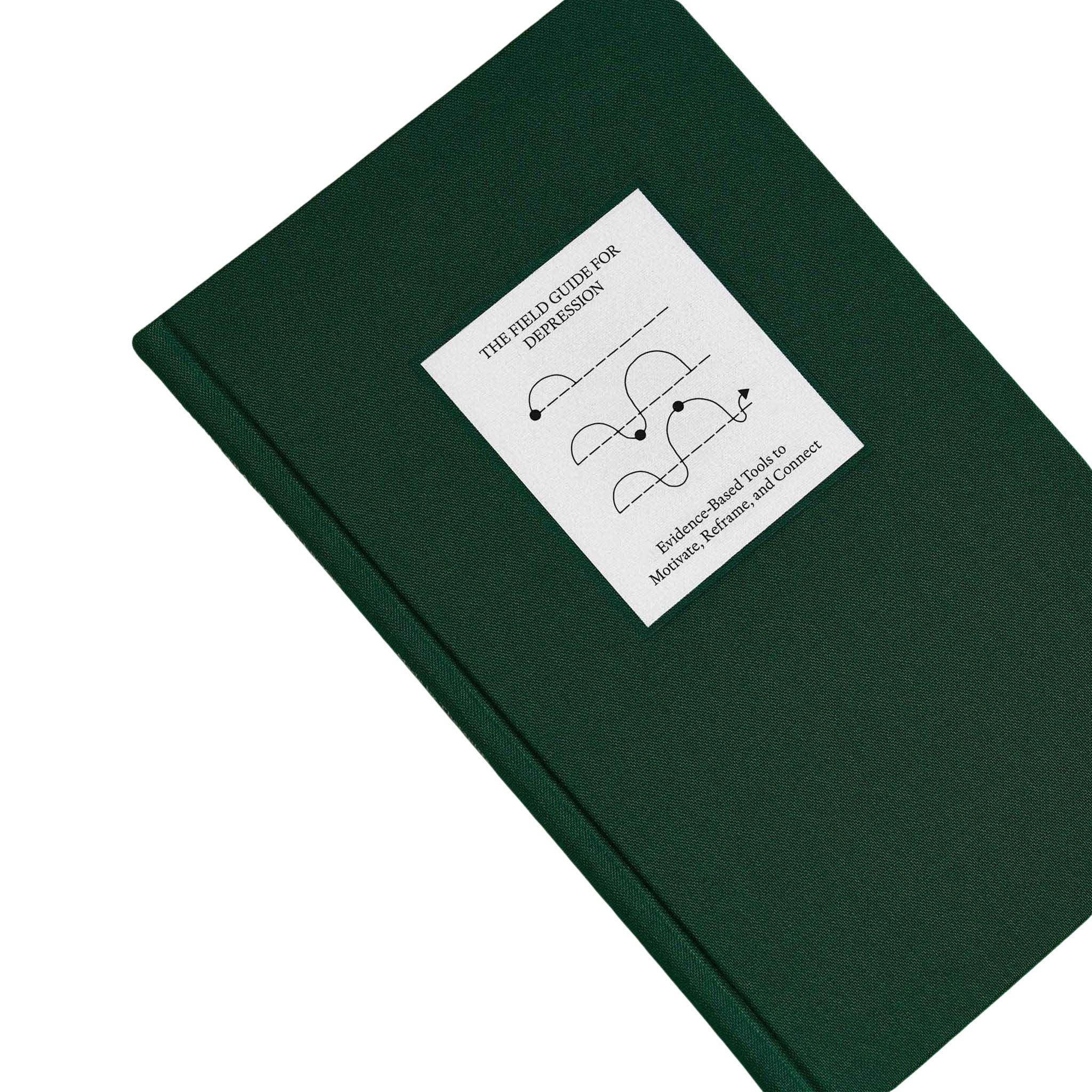 Top view of The Field Guide for Depression by Therapy Notebooks, featuring a linen hardcover with a minimalist stitched patch and embossed spine text.
