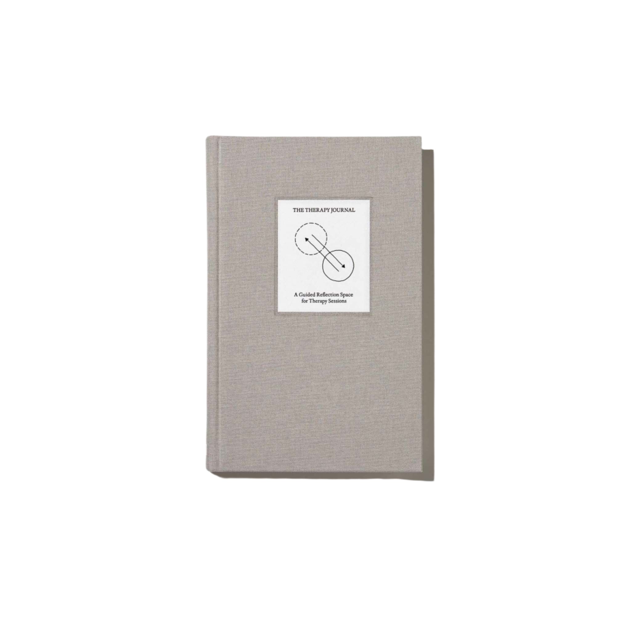 Top view of The Therapy Journal by Therapy Notebooks, featuring a linen hardcover with a minimalist stitched patch.