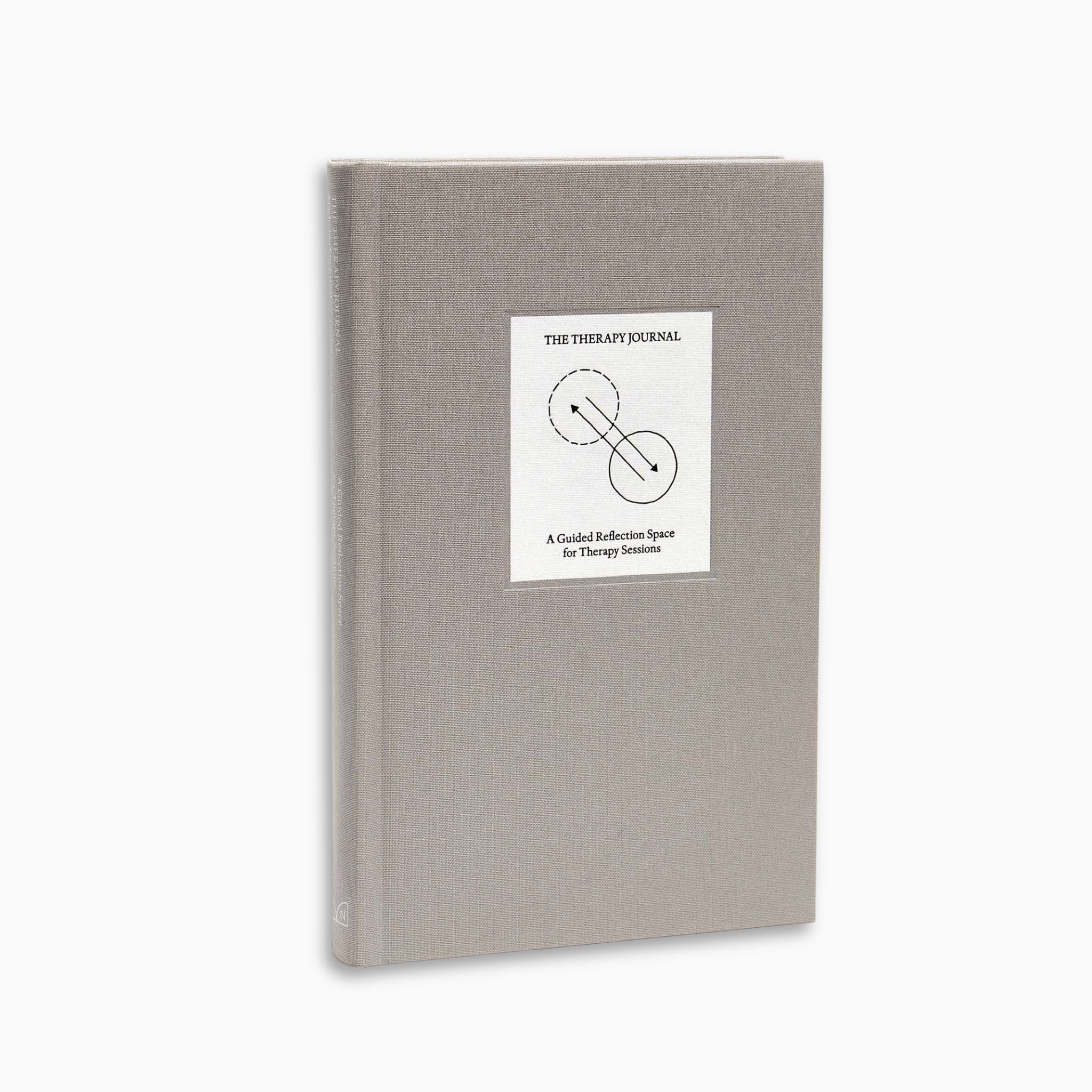 Full angled view of The Therapy Journal by Therapy Notebooks, featuring a linen hardcover with a minimalist stitched patch.